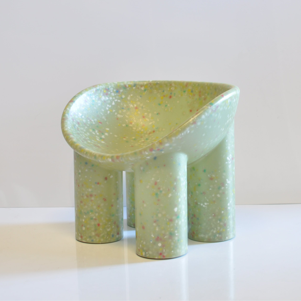 Modern kids confetti roly poly green chair with a textured surface on a white background
