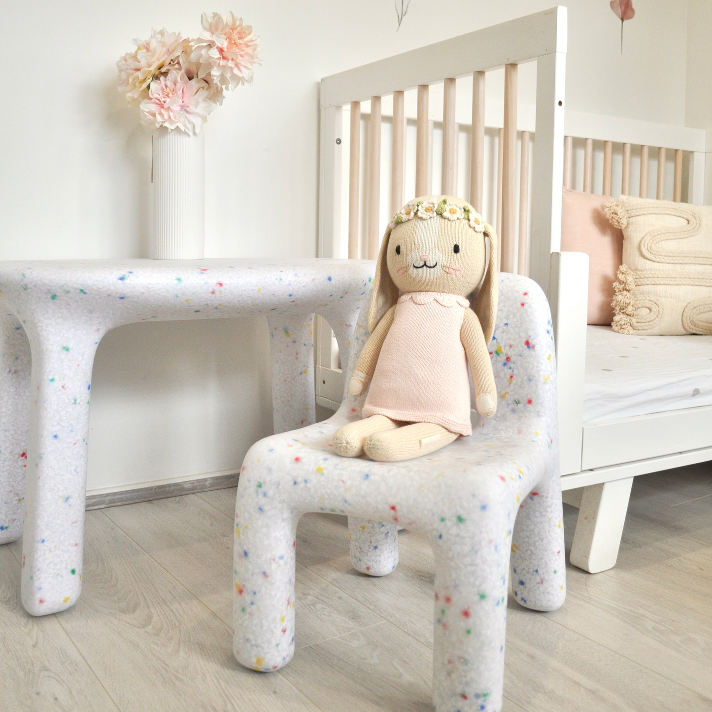 White Confetti Set with Bunny on chair in floral theme kids room, cropped image