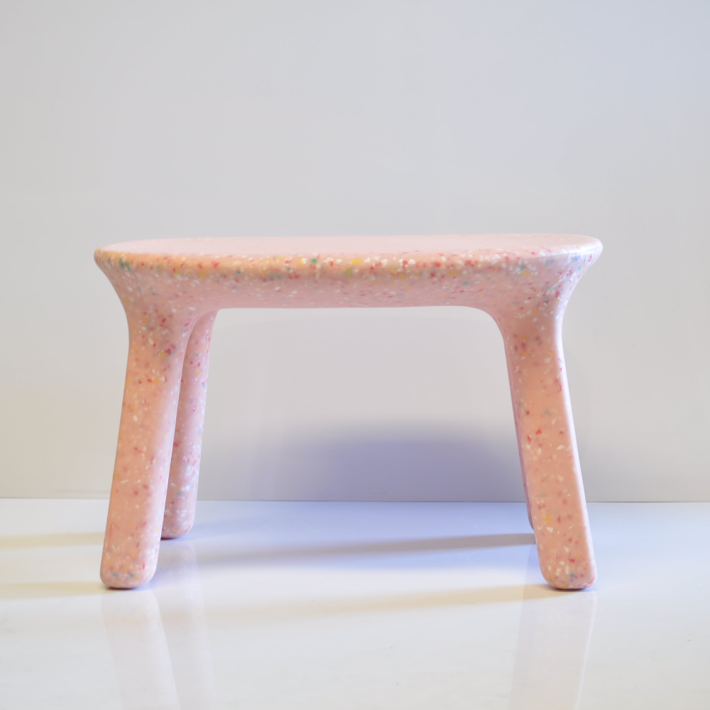 kids pink confetti table on a white surface with a light gray background