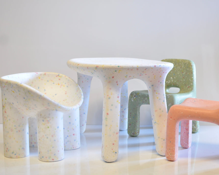 Set of colorful children's speckles confetti chairs and table on a white background