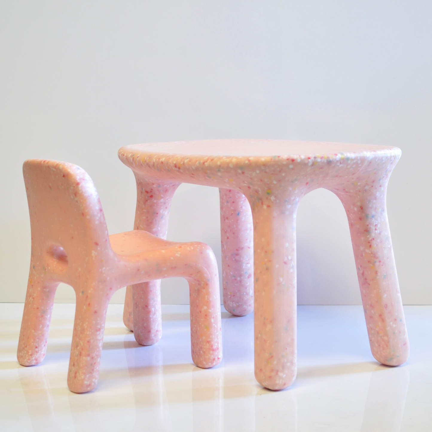 pink speckles confetti kids table and chair set with textured surface on a white background