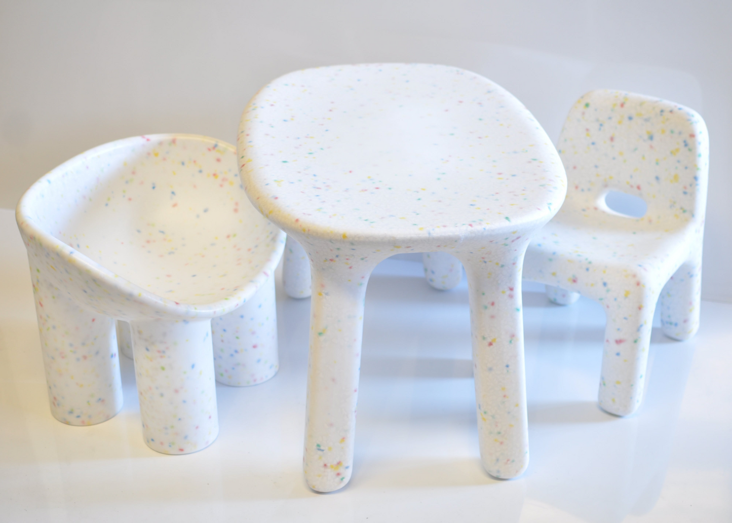Children's table and chairs set with a white surface and light-colored speckles.