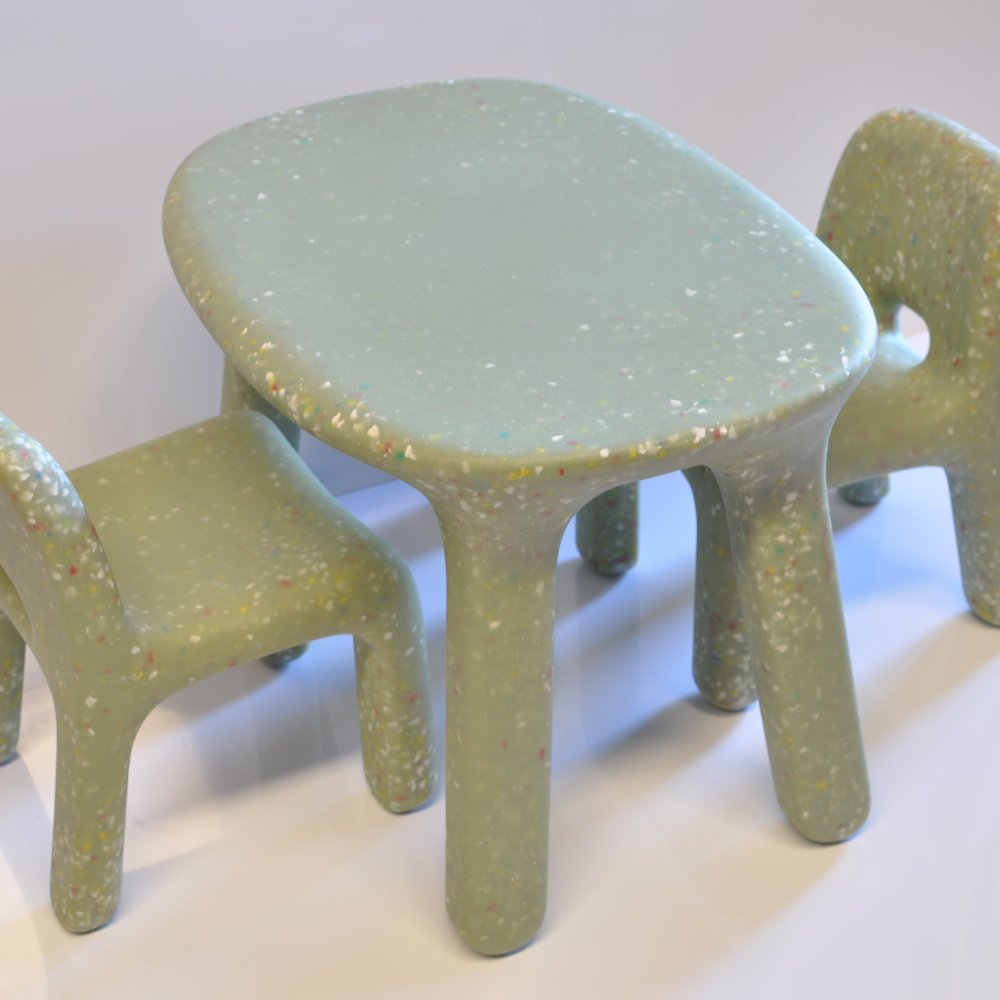 Children's green table and chairs set on a white background