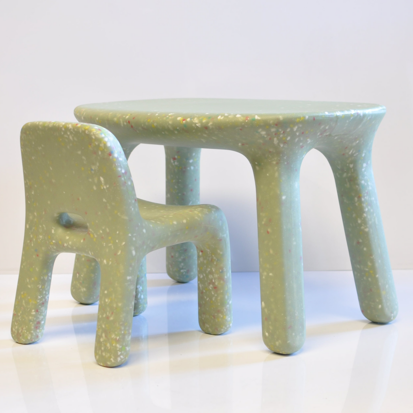 Confetti kids table and chair on a white surface.