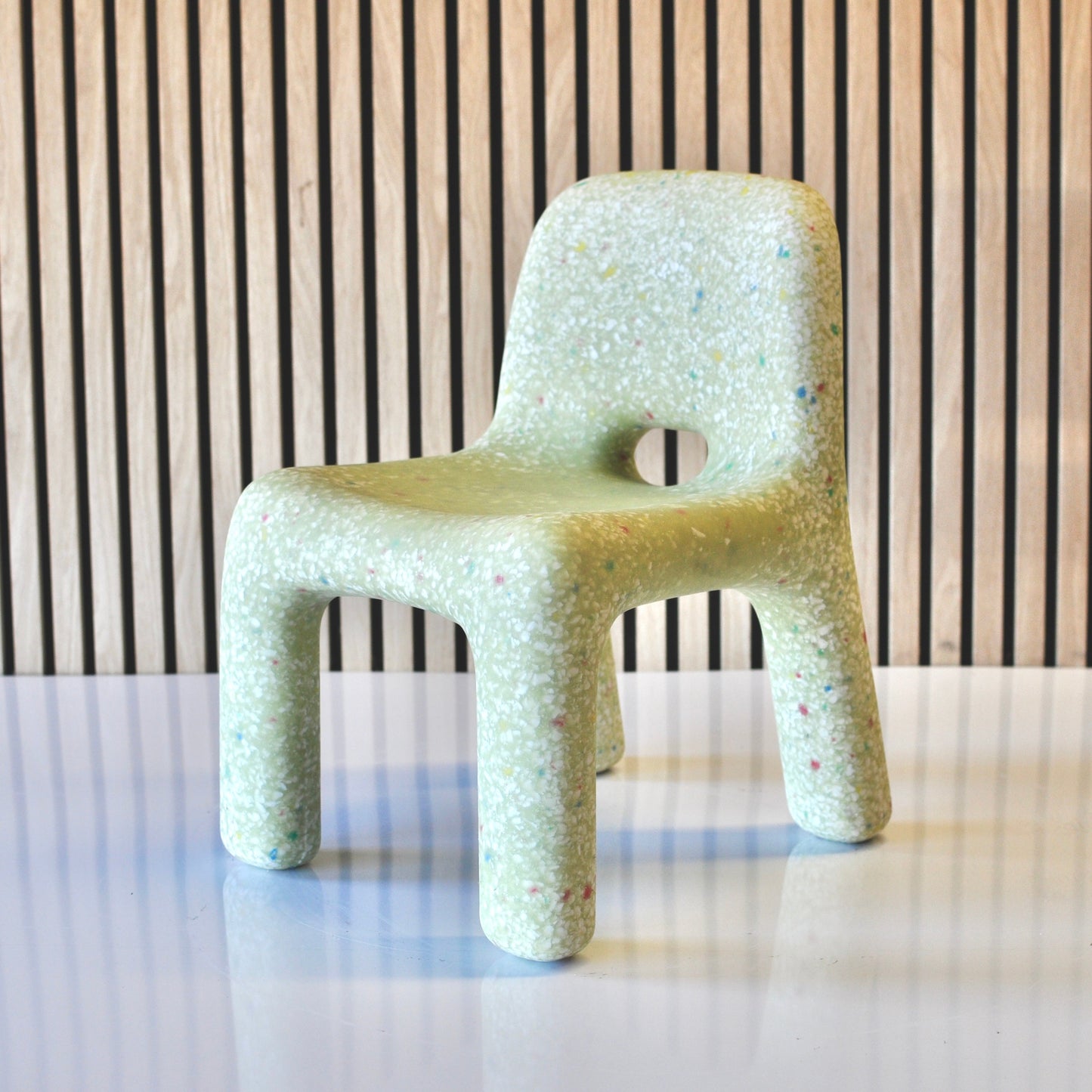 speckles kids matcha confetti chair green angled view on veneer background