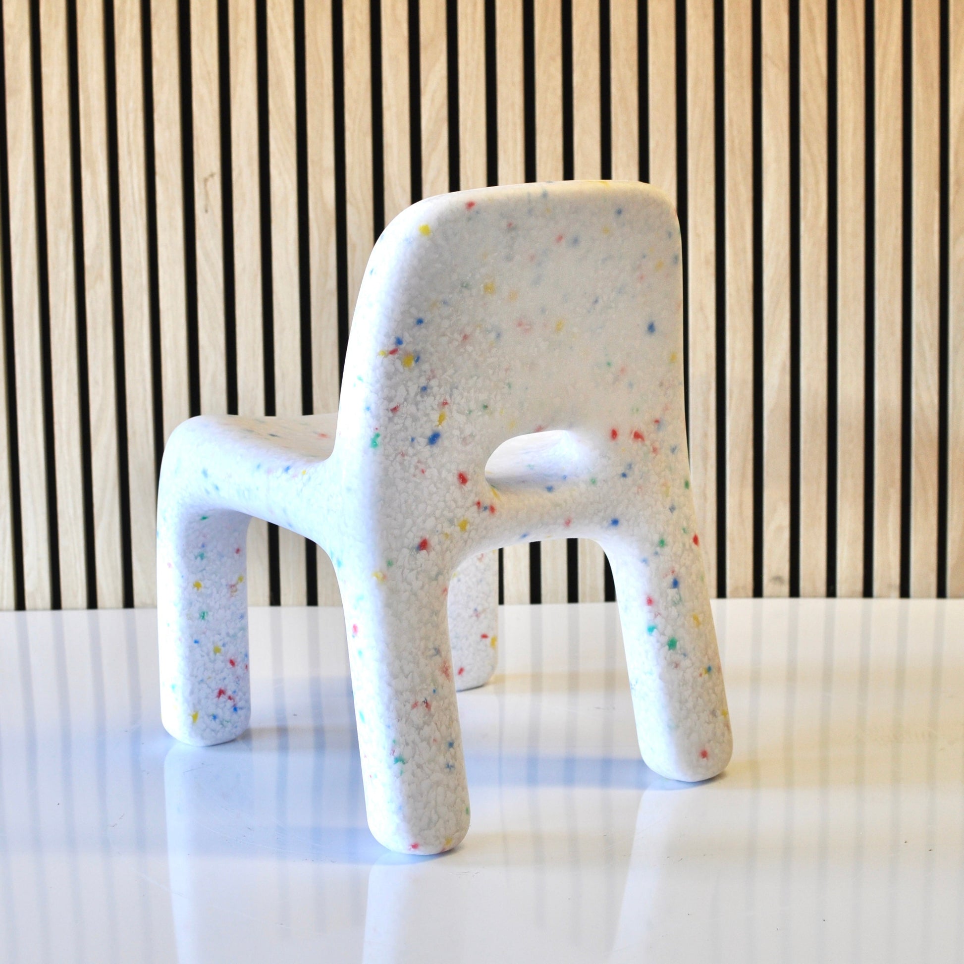 speckles kids white confetti chair angled view back on veneer background