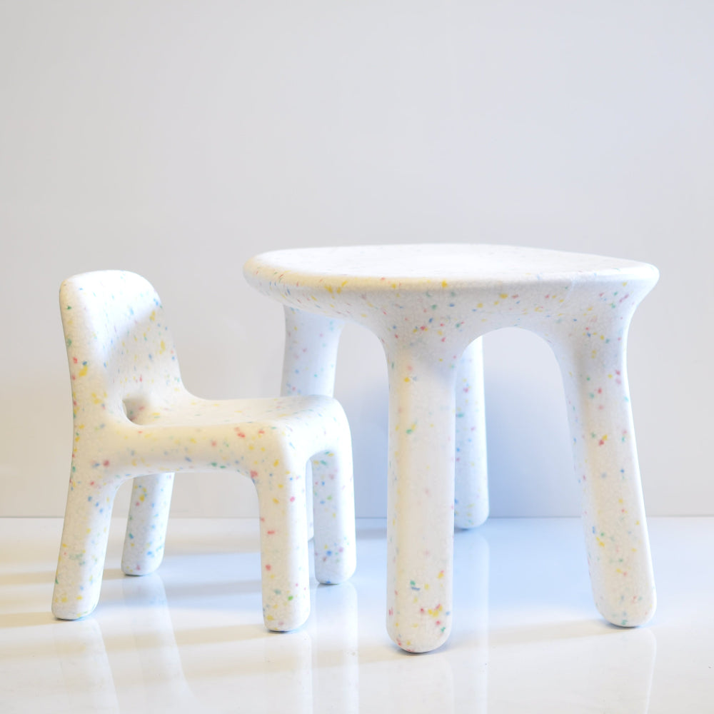 white kids confetti table and 1 chair set on a grey background