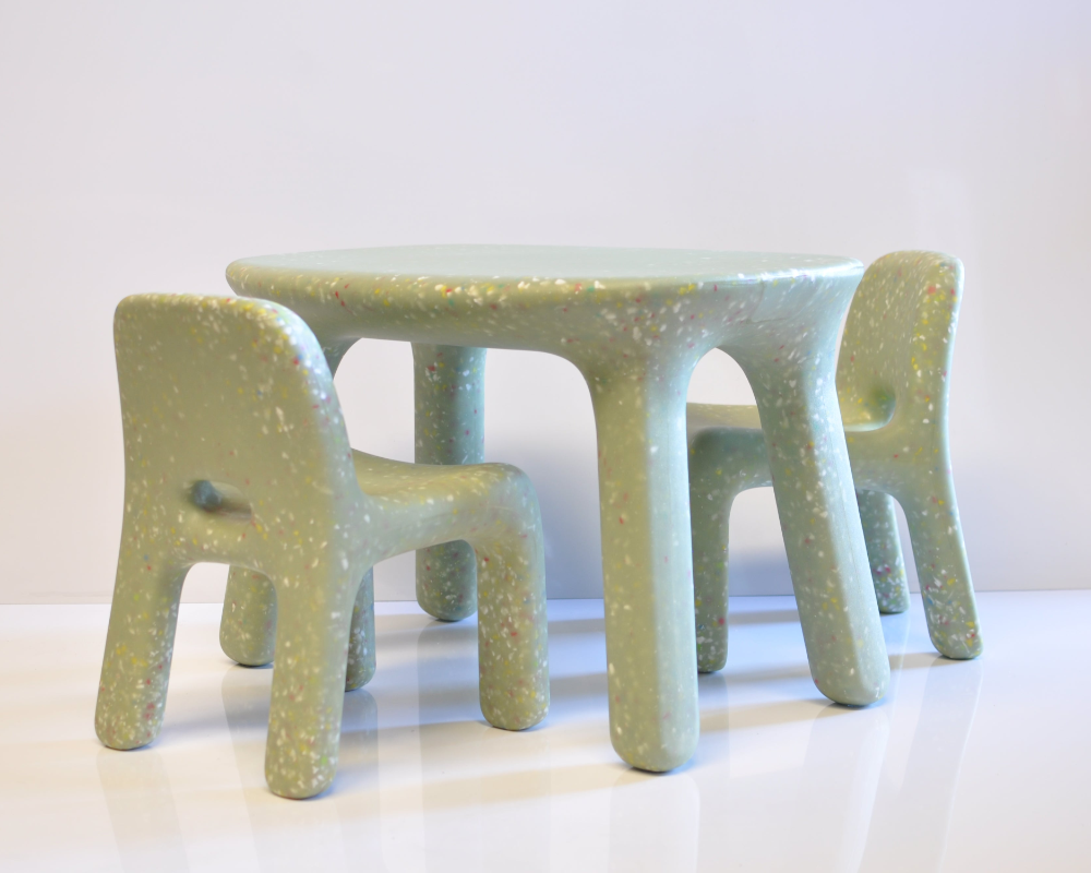 Set of green children's chairs and table on a white background