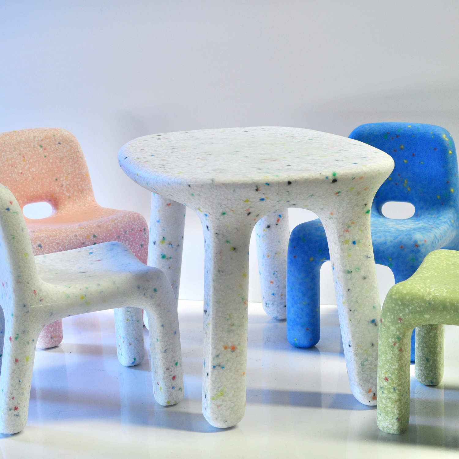 confetti table 4 chairs white pink blue and green on studio background square cropped