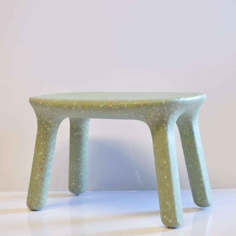 Green kids confetti table on a white surface with a light gray background