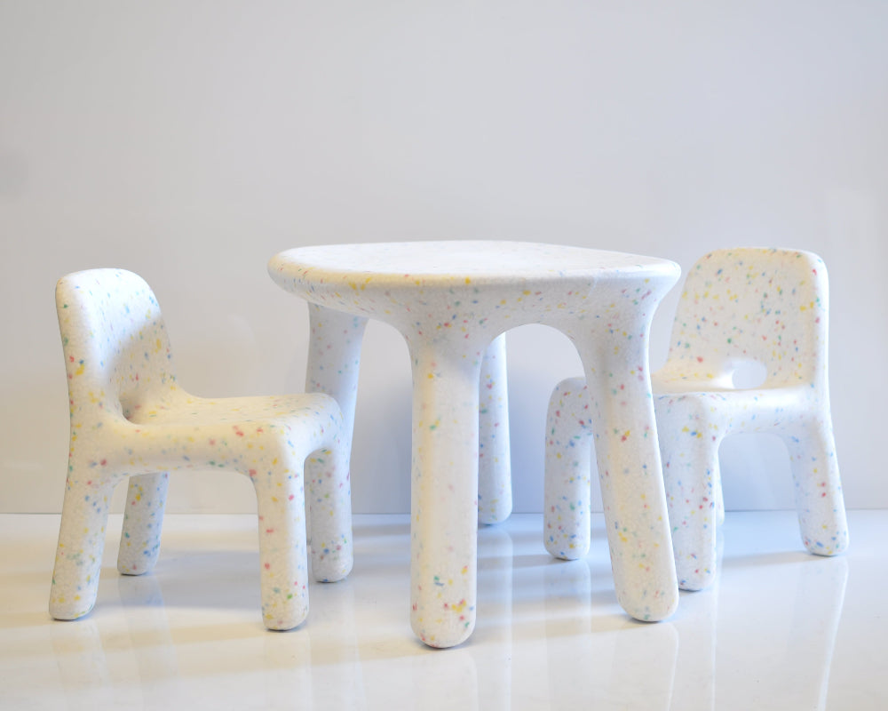 Children's table and chairs set with textured surface on a white background